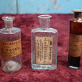 Lot 089 - Grouping Of Three Antique Hand Blown Glass Pontiled Bottles With Apothecary Labels Including Chloroform, Laudanum, And Gentian, Labels From Vermont And New York