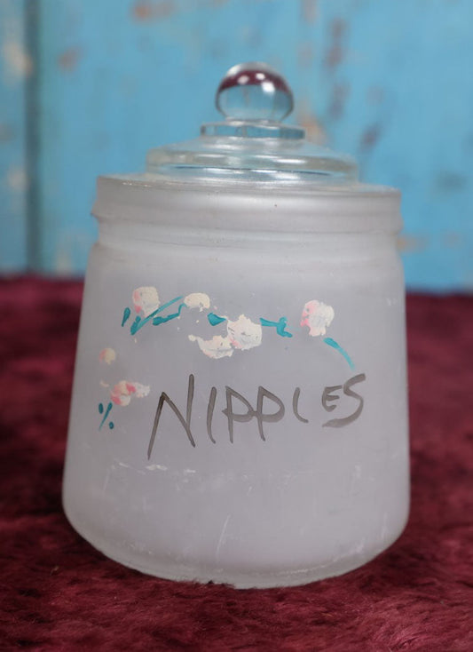 Lot 091 - Antique Hazel Atlas Frosted Glass Hand Painted "Nipples" Jar, Likely Used For Holding Baby Bottle Nipples, With Lid, Note Losses To Paint