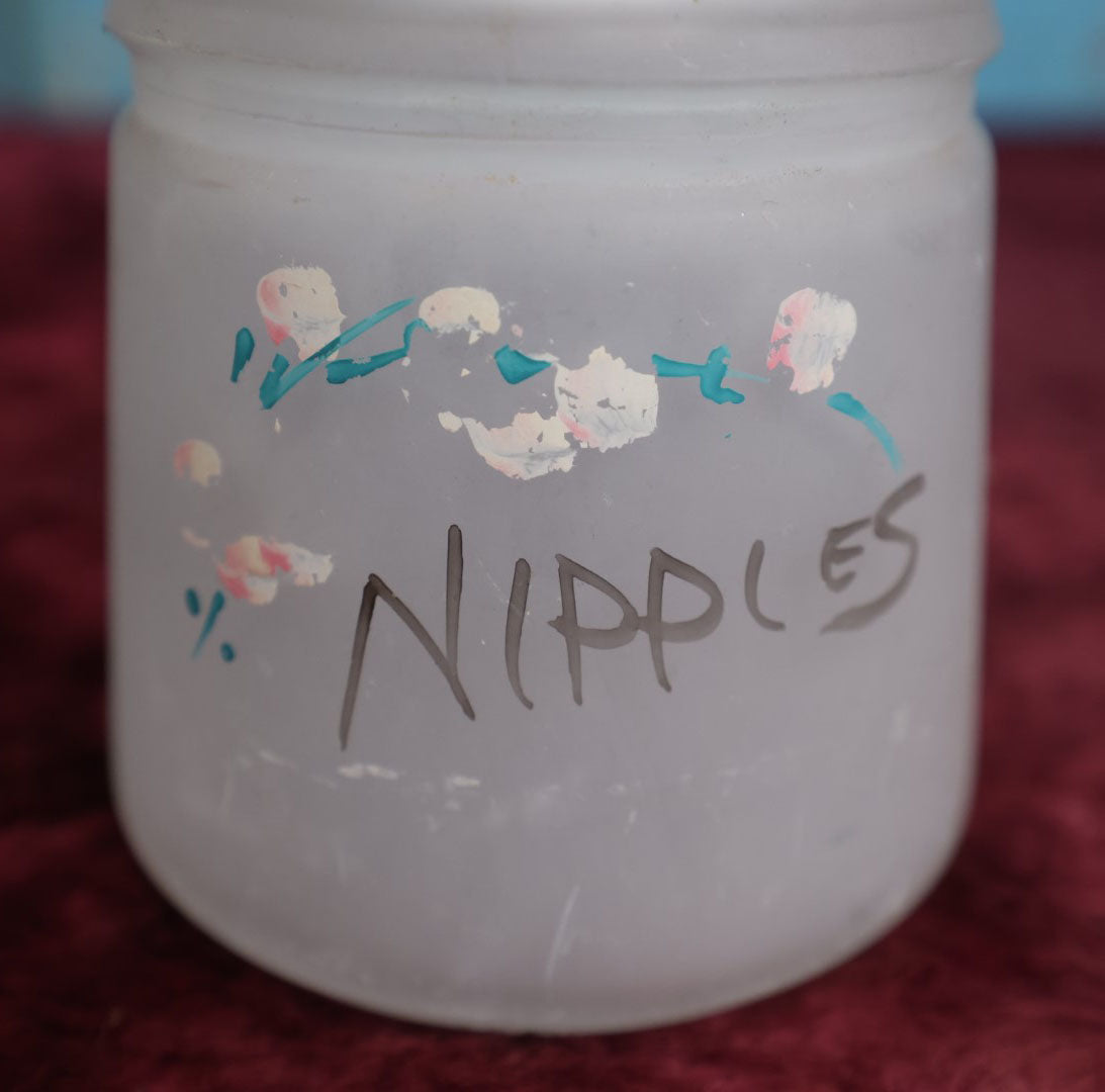 Lot 091 - Antique Hazel Atlas Frosted Glass Hand Painted "Nipples" Jar, Likely Used For Holding Baby Bottle Nipples, With Lid, Note Losses To Paint