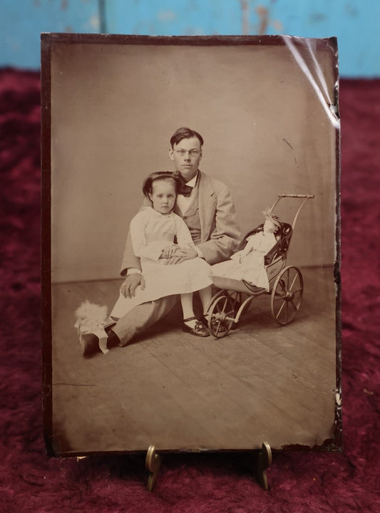 Lot 108 - Antique Tintype Photograph Of Father And Daughter With Doll In Pram, Approximately 1/2 Plate, Note Bend On Upper Corner