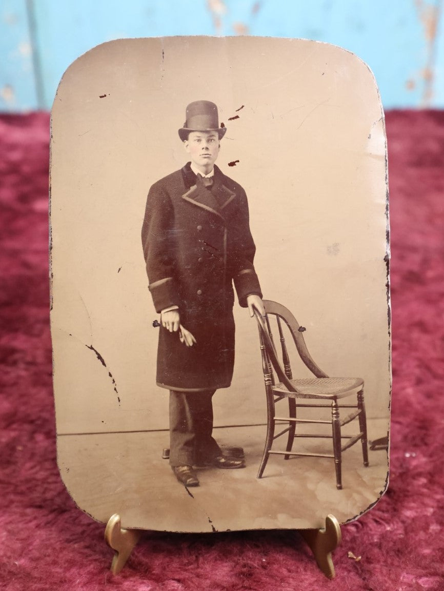 Lot 110 - Antique Tintype Of Young Boy In Long Peacoat, Tall Bowler Hat, Approximately 1/4 Plate