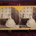 Lot 111 - Antique Spirit Photography Stereo Card, Woman At Table Looking At Photo Album With Spirit Behind Her, Dated 1869 By H.P. Moore, New Hampshire