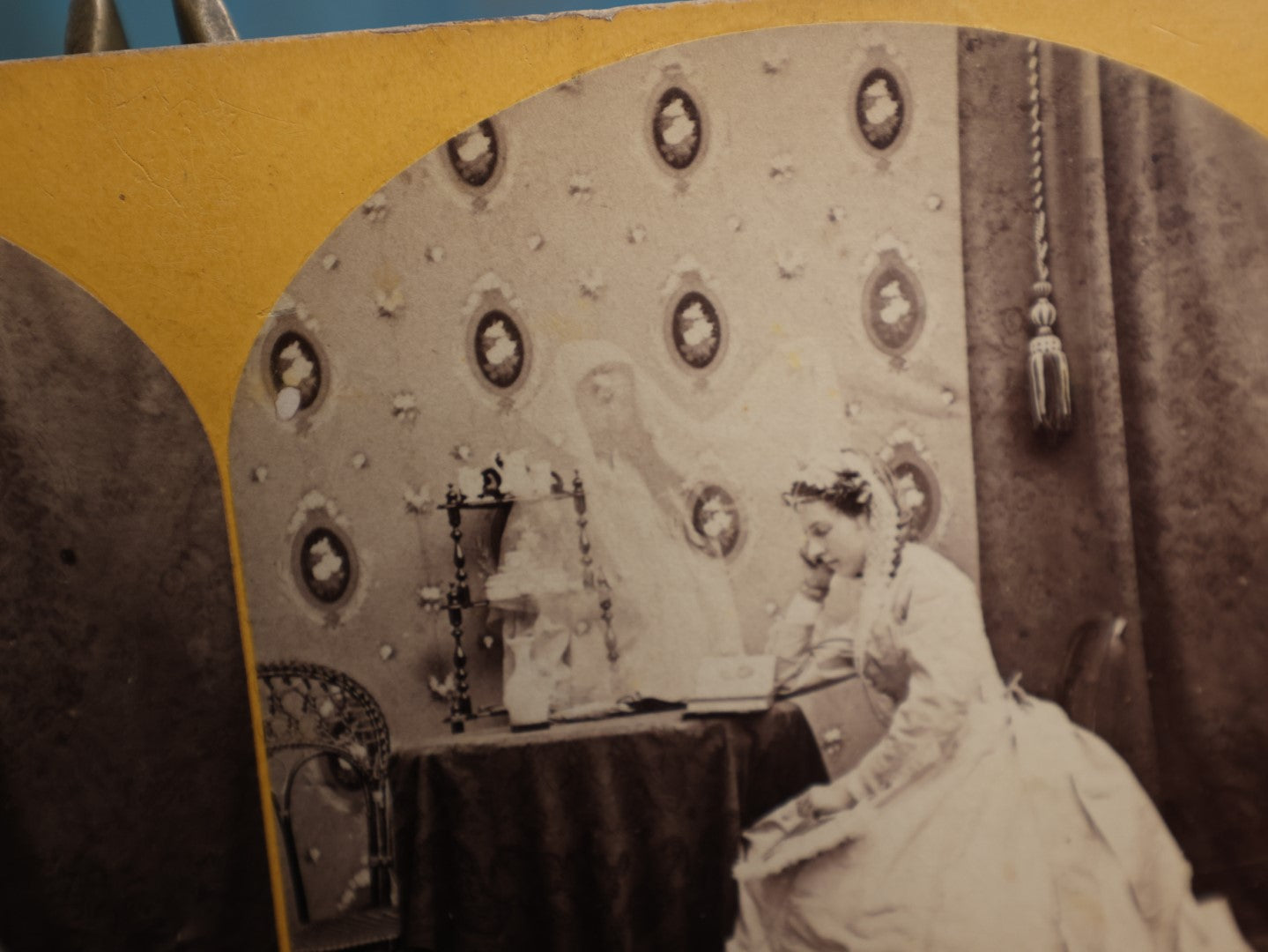 Lot 111 - Antique Spirit Photography Stereo Card, Woman At Table Looking At Photo Album With Spirit Behind Her, Dated 1869 By H.P. Moore, New Hampshire 