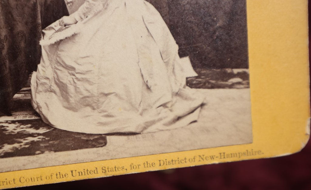 Lot 111 - Antique Spirit Photography Stereo Card, Woman At Table Looking At Photo Album With Spirit Behind Her, Dated 1869 By H.P. Moore, New Hampshire 