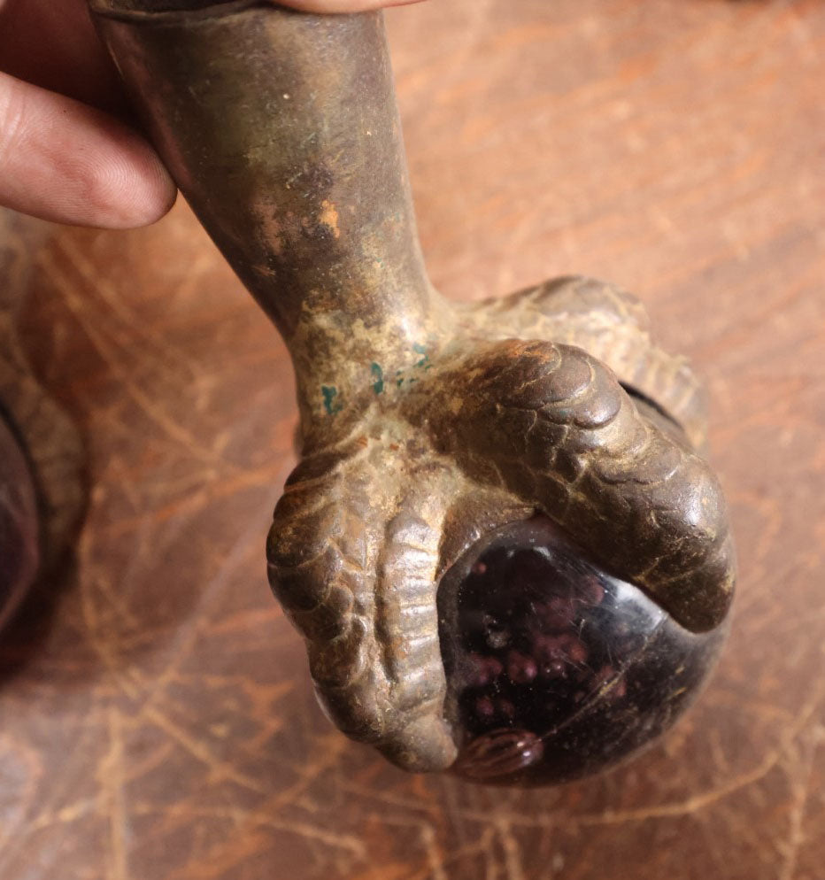 Lot 008 - Grouping Of Four Large Size Cast Iron And Glass Ball And Claw Furniture Feet With Purple Glass Balls