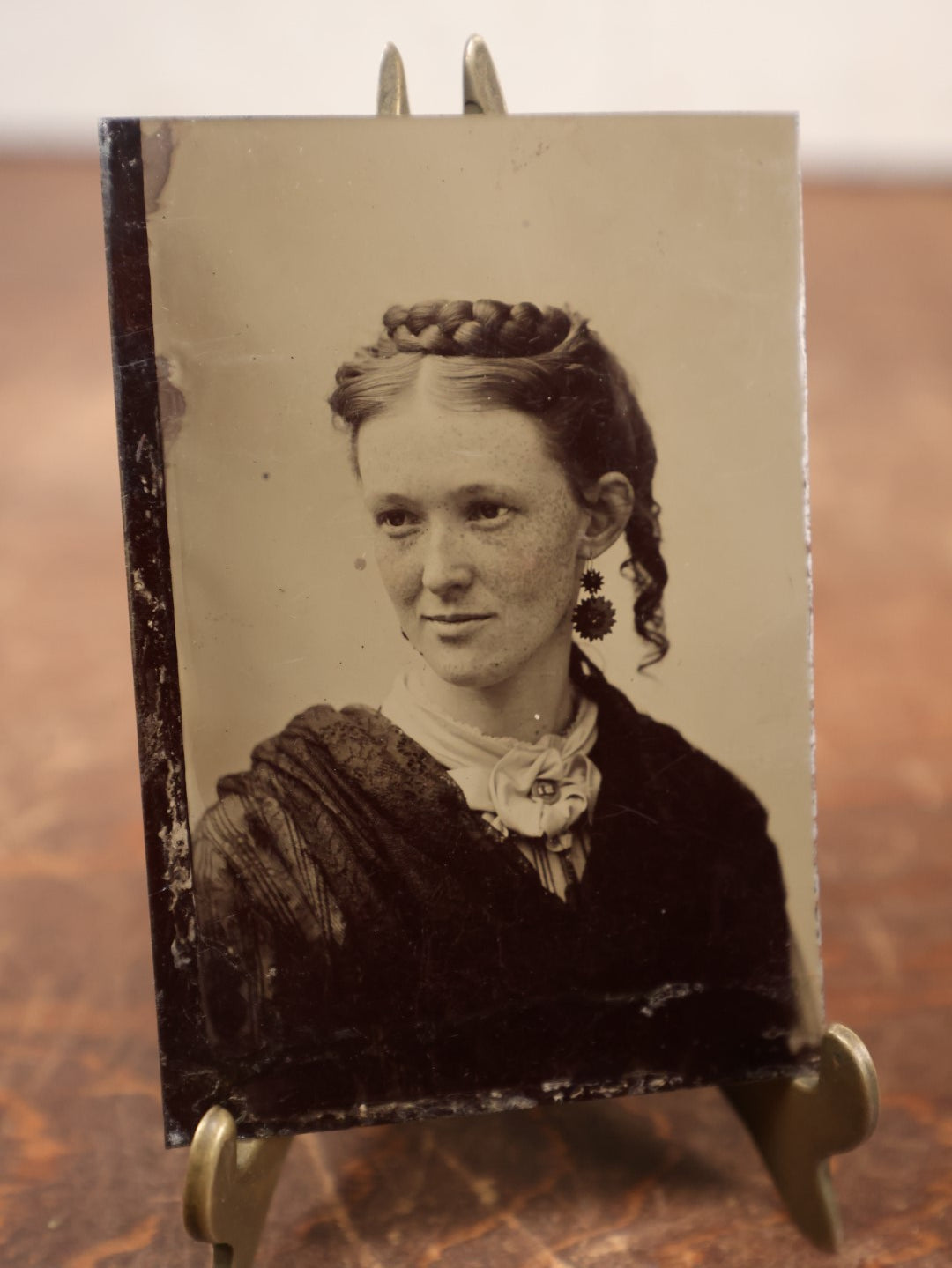 Lot 187 - Single Tintype Photo, Smiling Young Woman With Braided Hair On Top Of Head, Earrings, White Bow