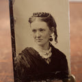 Lot 187 - Single Tintype Photo, Smiling Young Woman With Braided Hair On Top Of Head, Earrings, White Bow