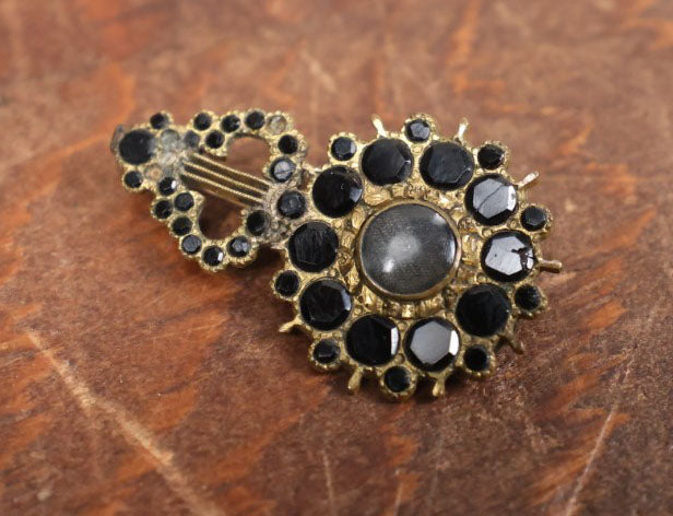 Lot 022 - Antique Brass Brooch With Black Stones And Woven Hair Under Glass Windows At Center, Note Scuff, Missing Stones