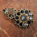 Lot 022 - Antique Brass Brooch With Black Stones And Woven Hair Under Glass Windows At Center, Note Scuff, Missing Stones