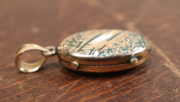 Lot 023 - Antique Brass And Enamel Locket With Small Hair Keepsake Memento Inside