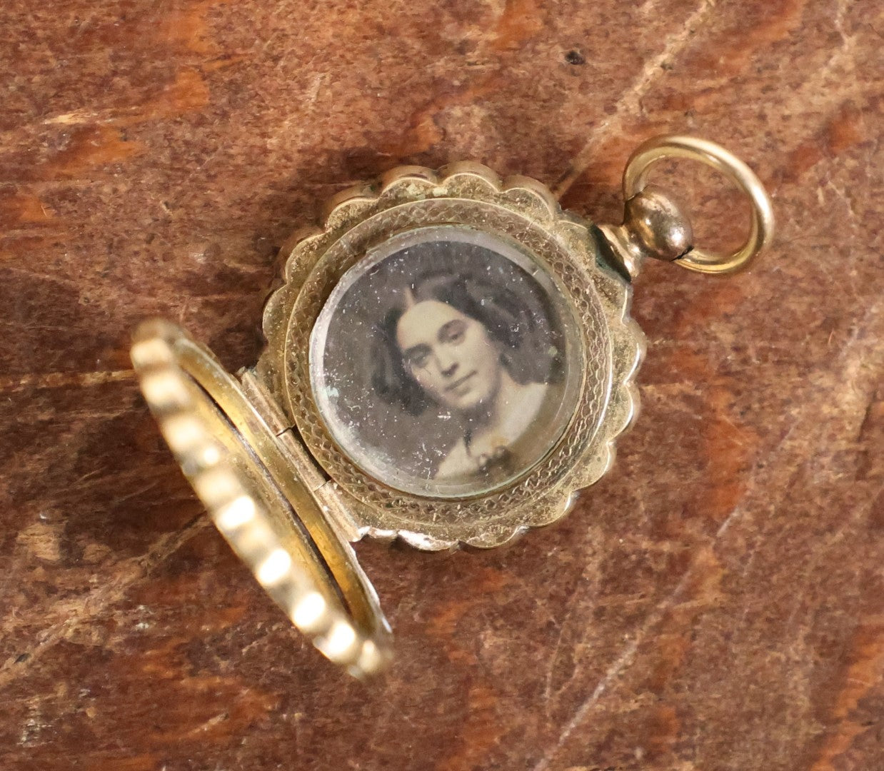 Lot 024 - Antique Brass And Blue Enamel Locket Containing A Miniature Daguerreotype Of A Pretty Young Woman