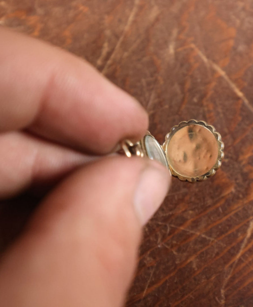 Lot 024 - Antique Brass And Blue Enamel Locket Containing A Miniature Daguerreotype Of A Pretty Young Woman