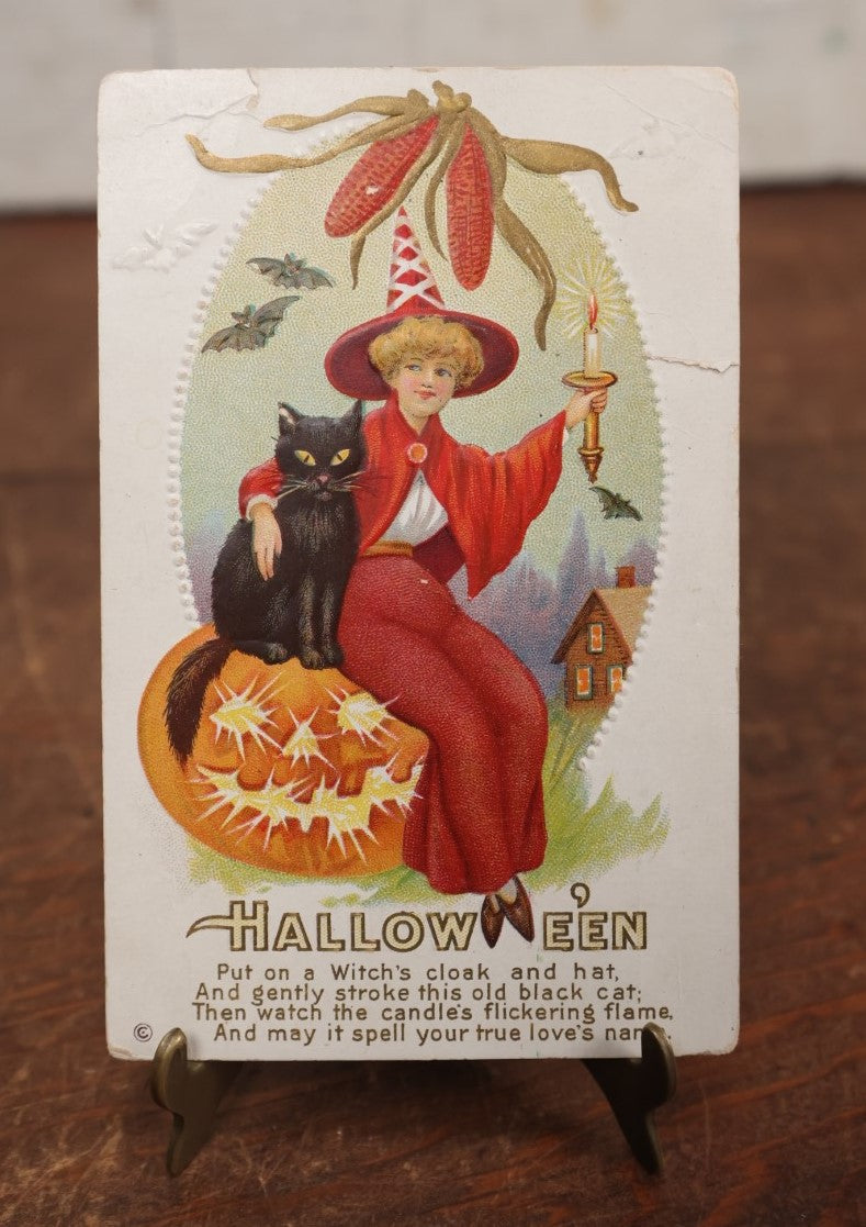 Lot 046 - Antique Embossed Halloween Postcard Of Young Witch In Red With Black Cat, Jack-O-Lantern, "Put On A Witch's Cloak," Note Small Tear