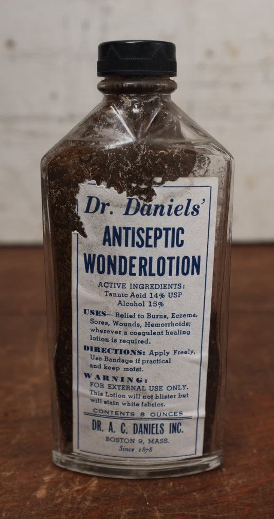 Lot 062 - Vintage Dr. Daniels' Antiseptic Wonderlotion Apothecary Bottle With Torn Paper Label, Treats Hemorrhoids, Sores, And Wounds