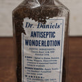 Lot 062 - Vintage Dr. Daniels' Antiseptic Wonderlotion Apothecary Bottle With Torn Paper Label, Treats Hemorrhoids, Sores, And Wounds