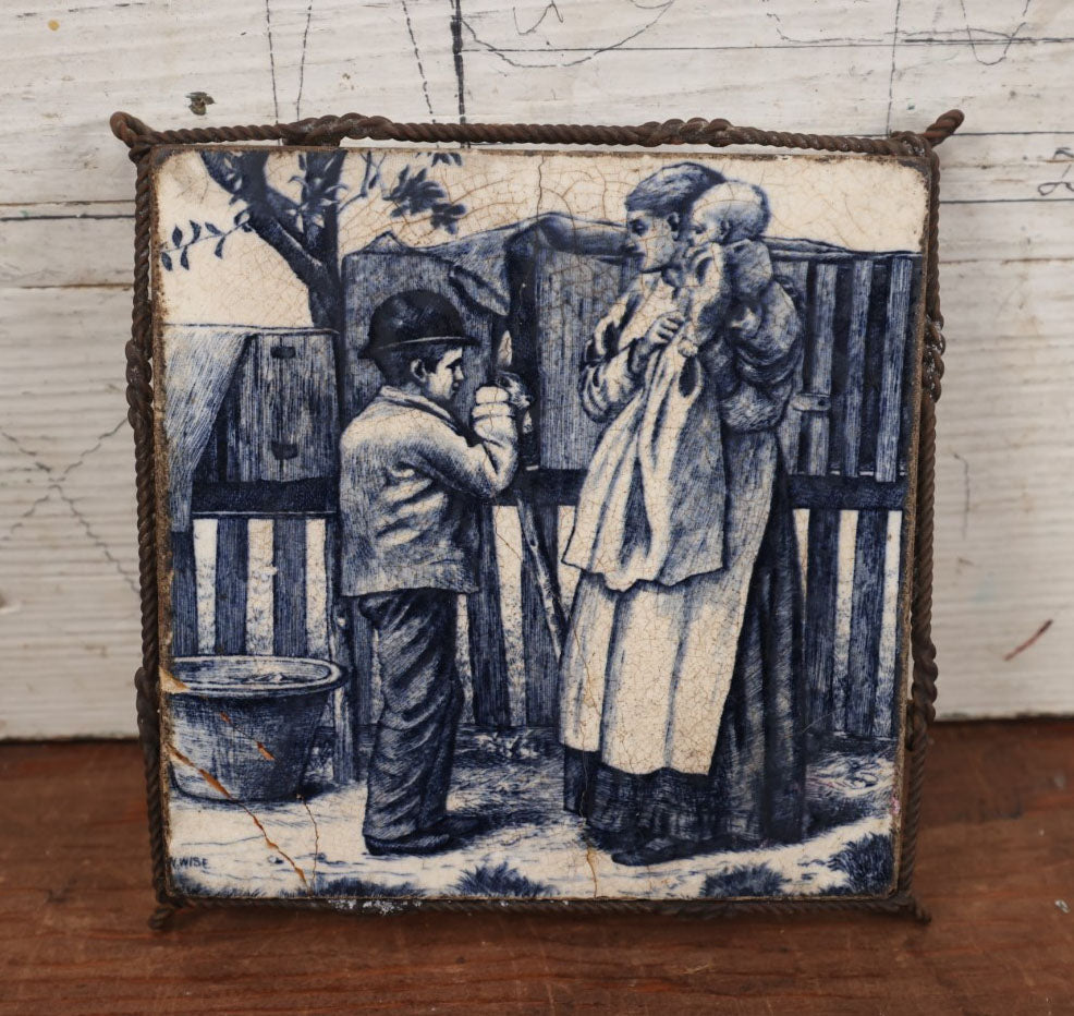 Lot 076 - Antique Painted Minton's English Tile In Frame Trivet / Wall Hanger, Young Boy Selling Rabbits, Note Severe Damage, Repairs