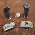 Lot 098 - Grouping Of Five Mixed Metal Accessories - Toothpick Cup, Belt Buckles, Shirt Button, Shaker
