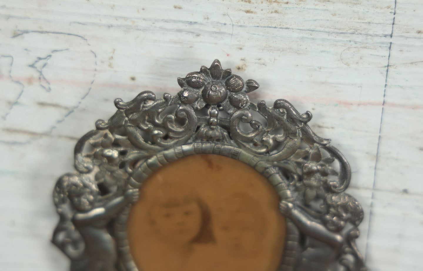 Lot 012 - Diminutive Antique Cast Silvertone Metal Frame With Cherubs On Sides, From Florence, Italy, By George W. Child, Containing An Identified Photo Of Lora F. Child And Donald Pratt, Circa 1895