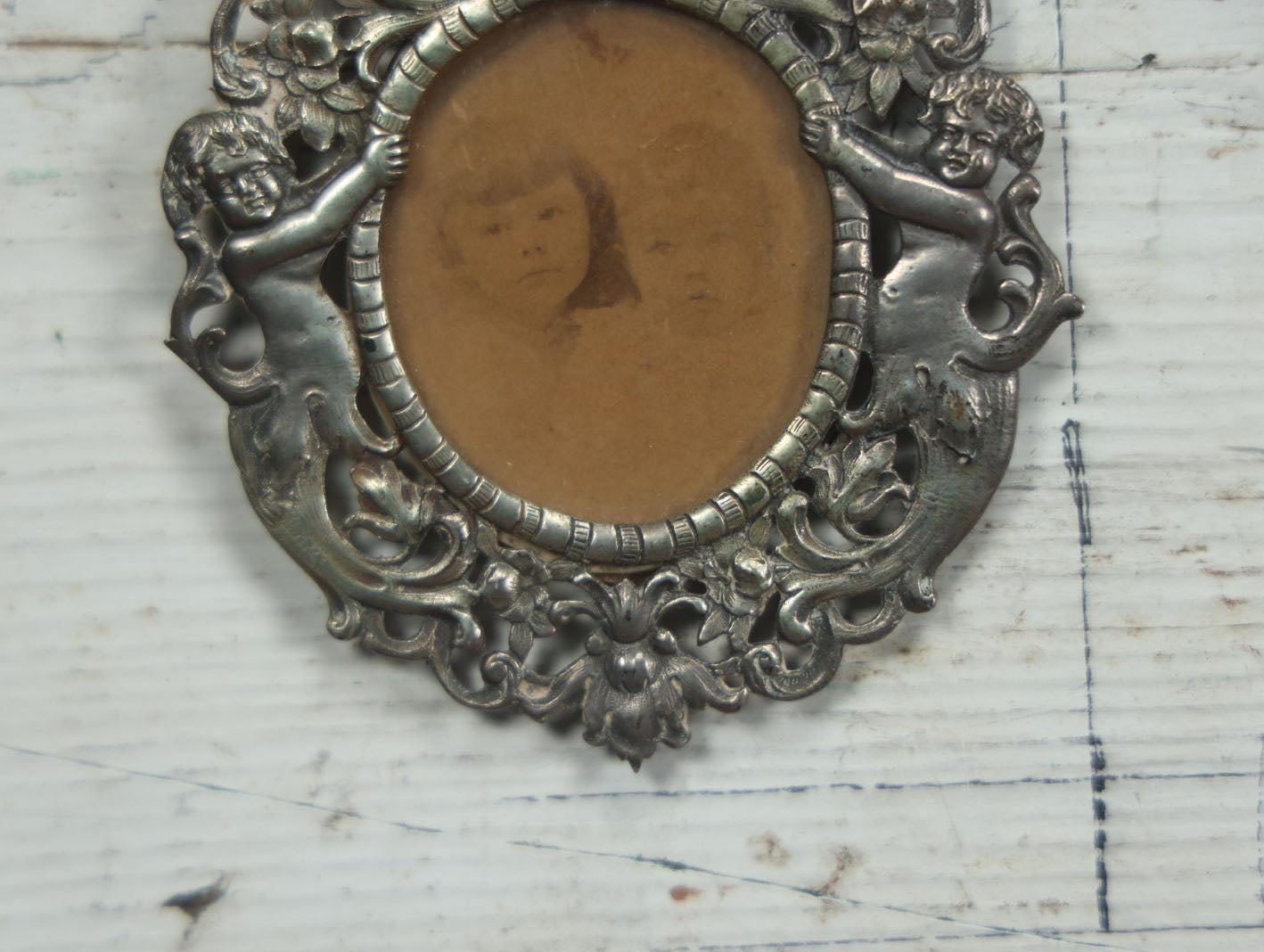 Lot 012 - Diminutive Antique Cast Silvertone Metal Frame With Cherubs On Sides, From Florence, Italy, By George W. Child, Containing An Identified Photo Of Lora F. Child And Donald Pratt, Circa 1895