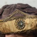 Lot 025 - Antique Fraternal Theatrical Medieval Hat With Jeweled Crest, Gold And Faded Purple, Note Wear Throughout