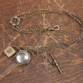 Lot 051 - Antique Watch Chain With Charms Including Square Monogrammed B Locket, Glass Windowed Piece