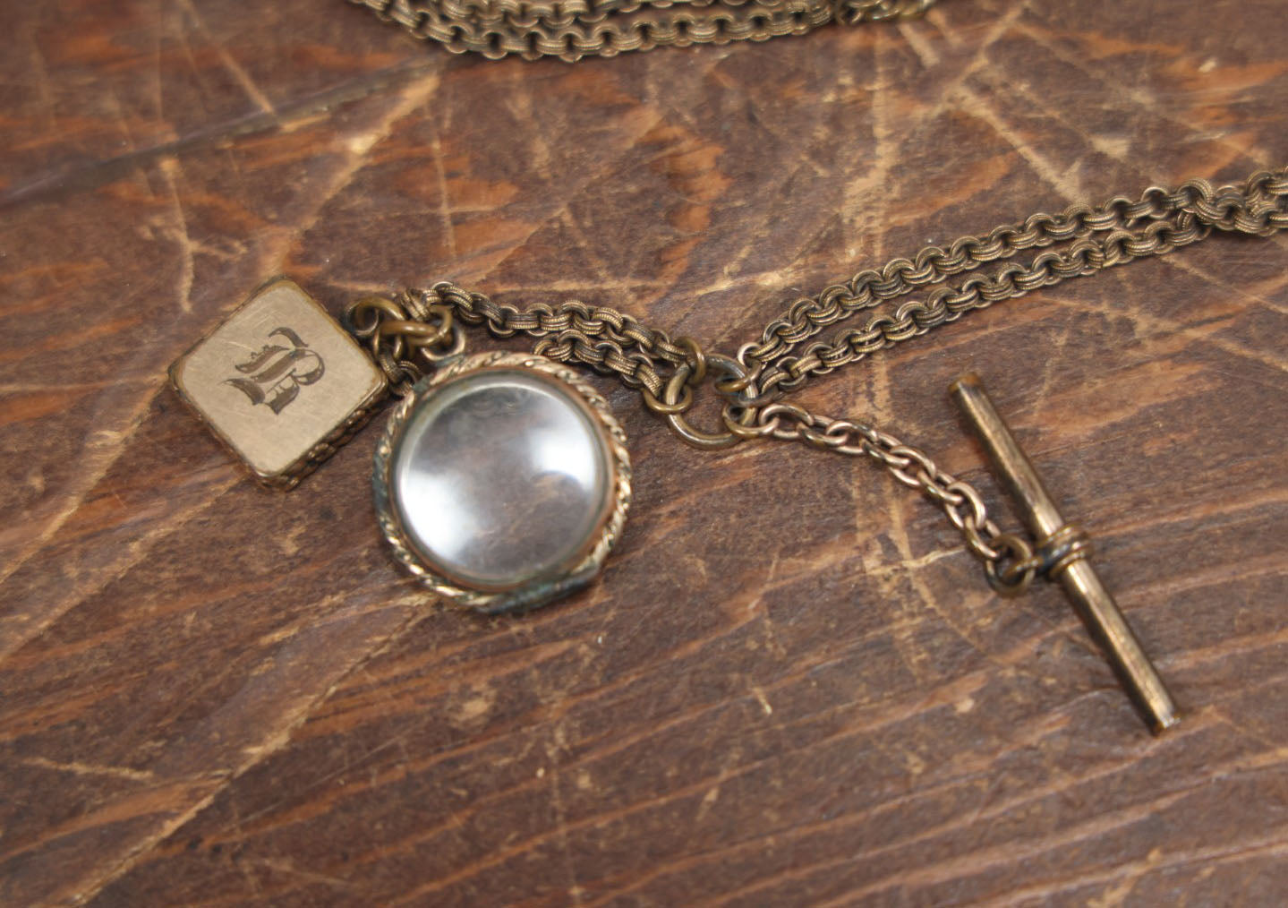 Lot 051 - Antique Watch Chain With Charms Including Square Monogrammed B Locket, Glass Windowed Piece