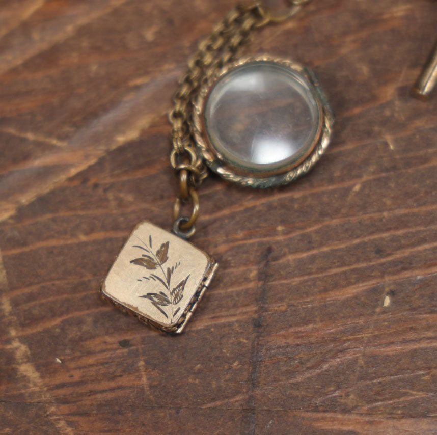 Lot 051 - Antique Watch Chain With Charms Including Square Monogrammed B Locket, Glass Windowed Piece