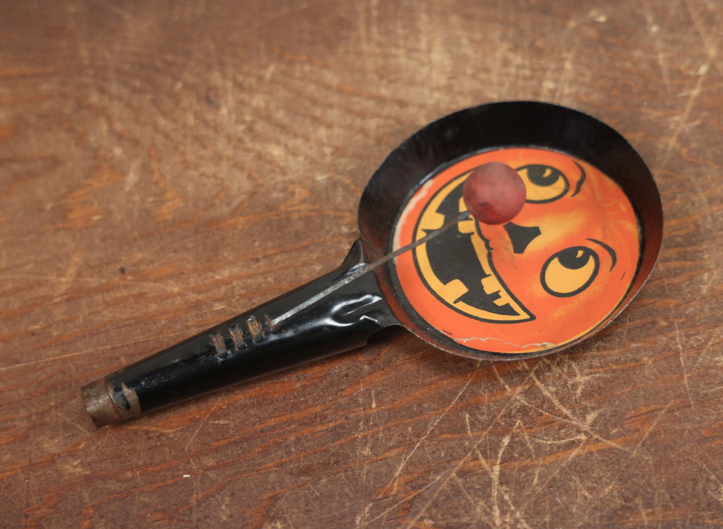 Lot 055 - Vintage Jack-O-Lantern Pumpkin Halloween Noisemaker With Printed Paper Face, Tin Body, Originally Also A Whistle, Missing One Ball, Note Damage