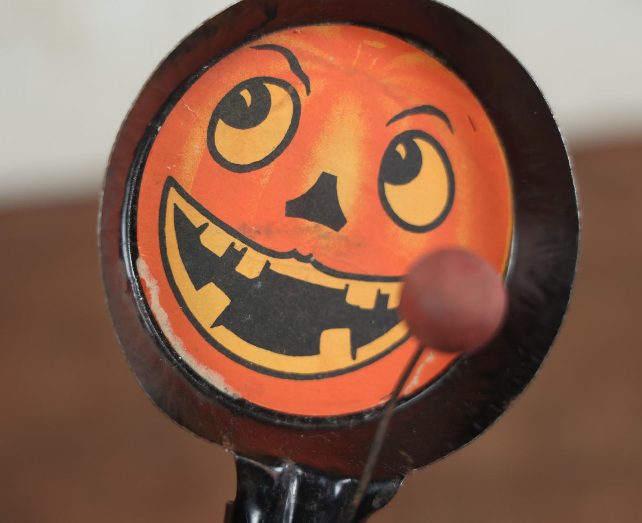 Lot 055 - Vintage Jack-O-Lantern Pumpkin Halloween Noisemaker With Printed Paper Face, Tin Body, Originally Also A Whistle, Missing One Ball, Note Damage