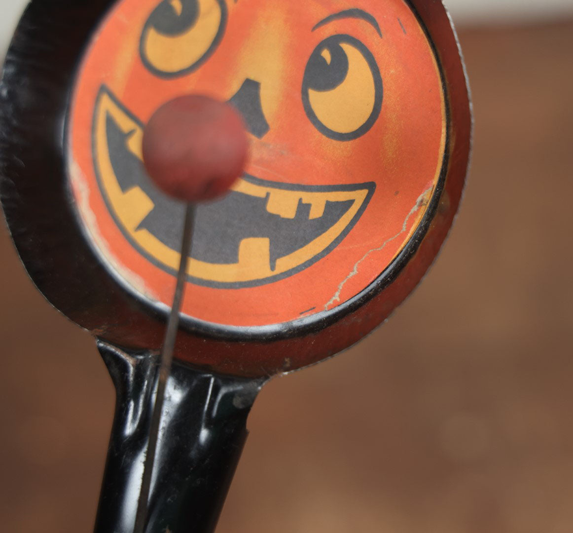 Lot 055 - Vintage Jack-O-Lantern Pumpkin Halloween Noisemaker With Printed Paper Face, Tin Body, Originally Also A Whistle, Missing One Ball, Note Damage