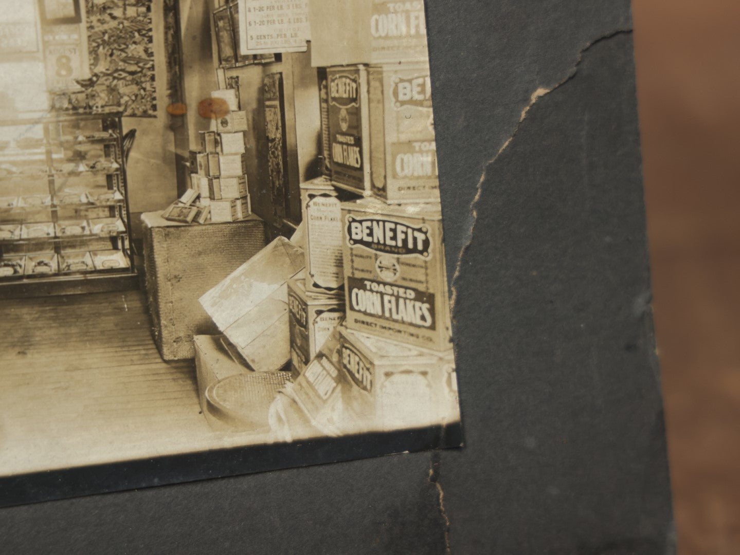 Lot 076 - Antique Boarded Occupational Photograph Of A Handsome Shopkeeper In A General Store, With Advertising, Chinese Lanterns With Tea Ads, And More, Note Bend In Corner