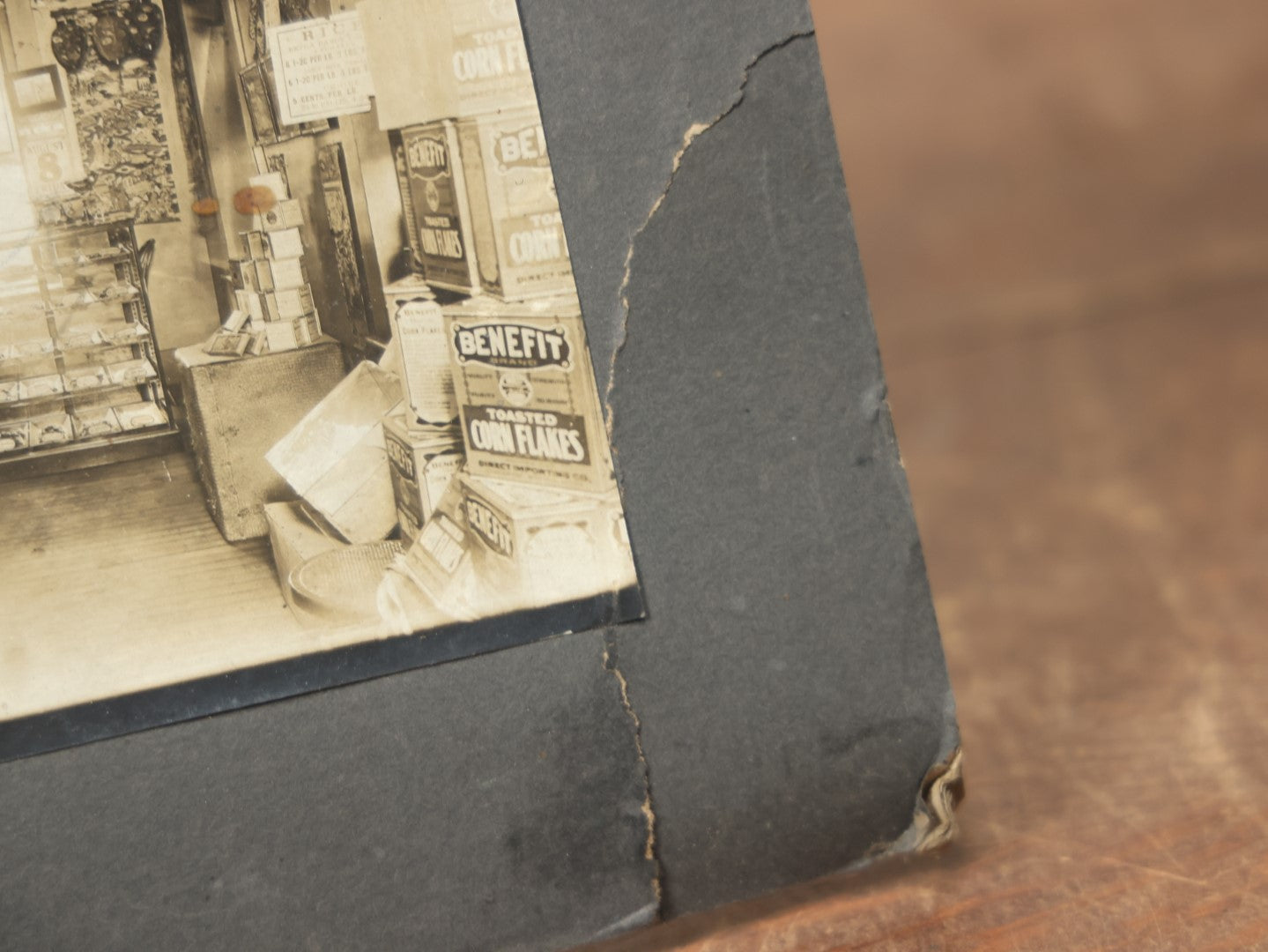 Lot 076 - Antique Boarded Occupational Photograph Of A Handsome Shopkeeper In A General Store, With Advertising, Chinese Lanterns With Tea Ads, And More, Note Bend In Corner