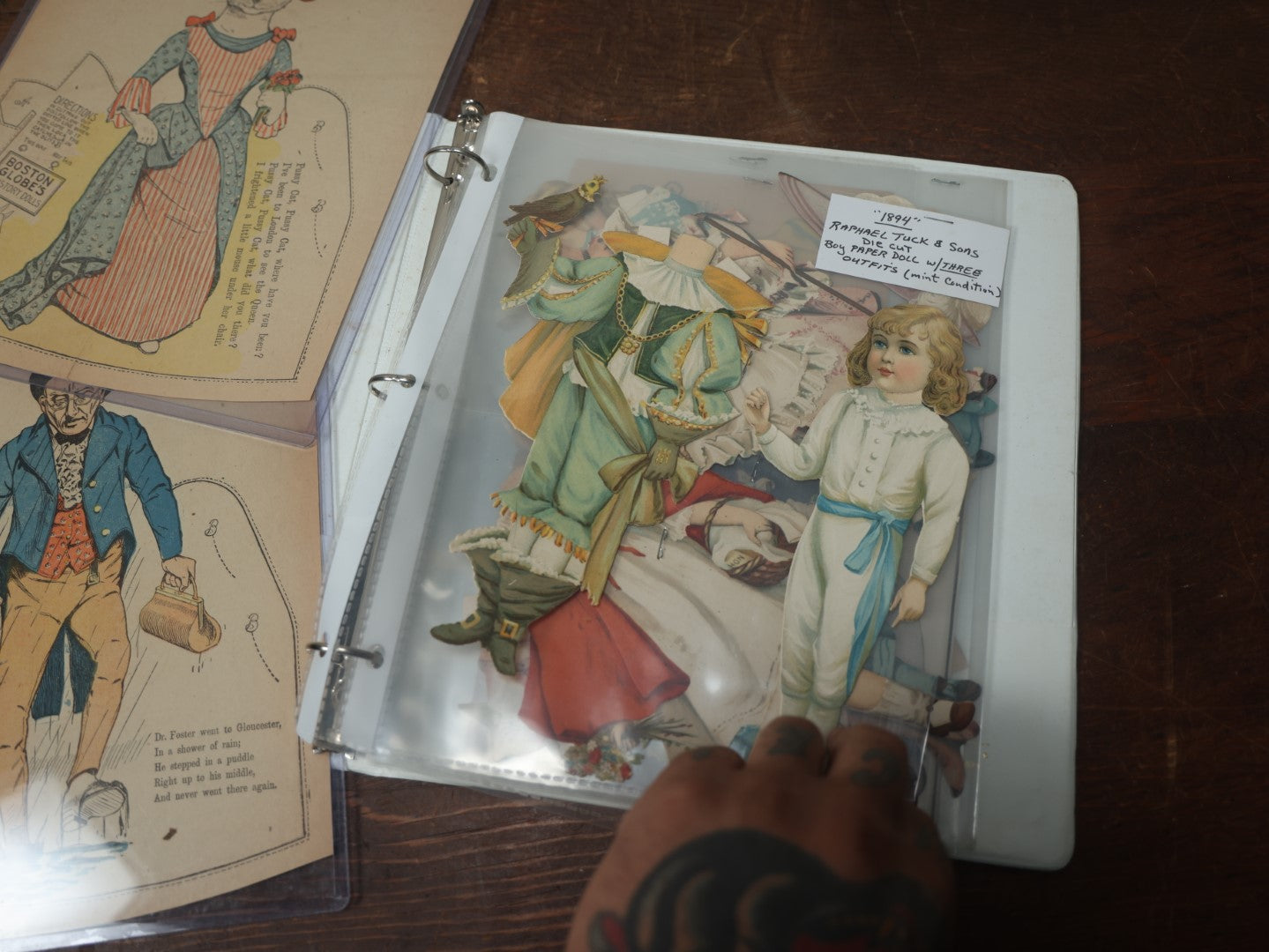 Lot 102 - Large Grouping Of Paper Dolls In Binder, Including Dolls And Outfits By Raphael Tuck & Sons