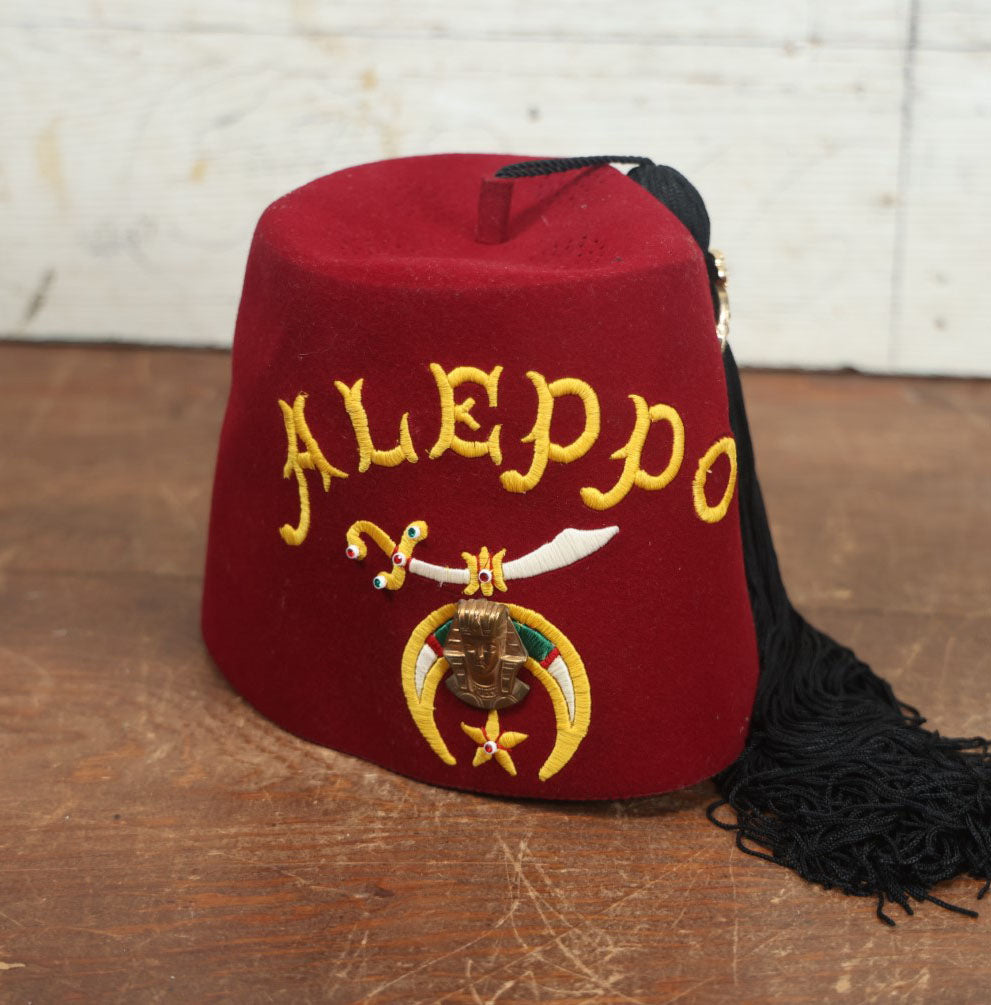 Lot 049 - Vintage Aleppo Shriners Masonic Fraternal Red Fez With Black Tassel, Bejeweled Brooch, Size 7-1/8