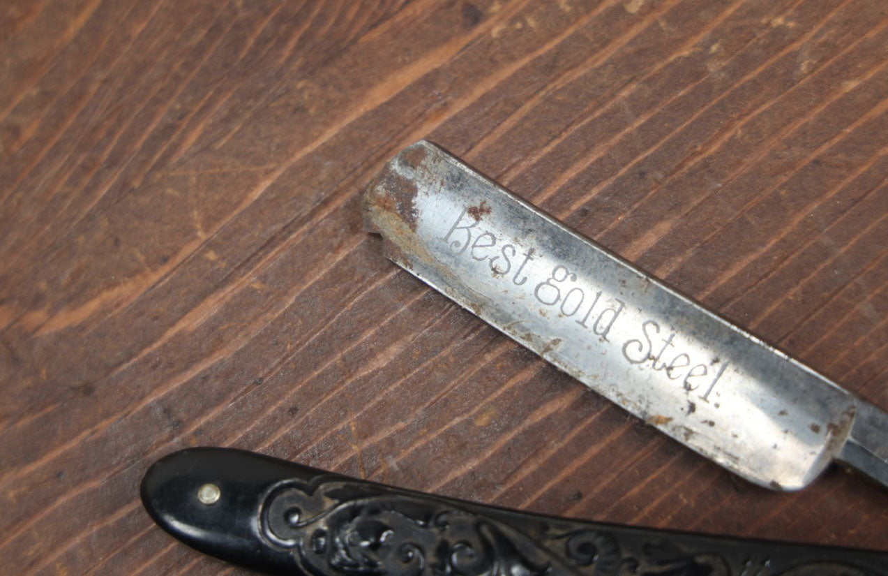 Lot 056 - Antique Best Gold Steel Straight Razor With Ornate Black Handle, Marked 160, Note Chips To Blade