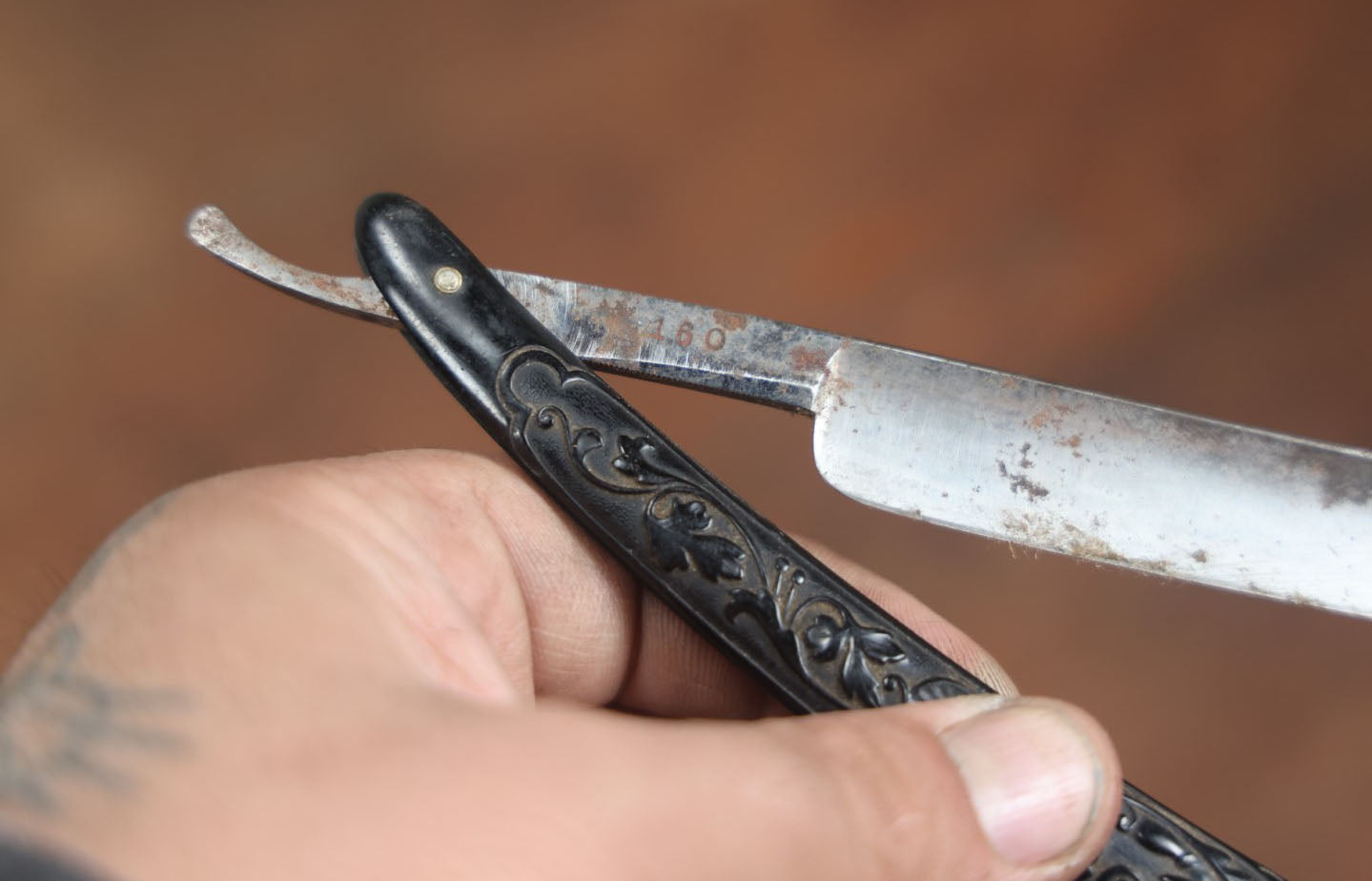 Lot 056 - Antique Best Gold Steel Straight Razor With Ornate Black Handle, Marked 160, Note Chips To Blade