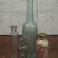 Lot 072 - Grouping Of Four Antique And Vintage Apothecary And Pharmacy Bottles - Florida Water, Upjohn Friable Pills, Daniels Veterinary Colic Cure, Roche's Hooping Cough