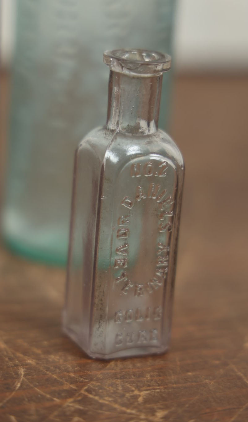 Lot 072 - Grouping Of Four Antique And Vintage Apothecary And Pharmacy Bottles - Florida Water, Upjohn Friable Pills, Daniels Veterinary Colic Cure, Roche's Hooping Cough