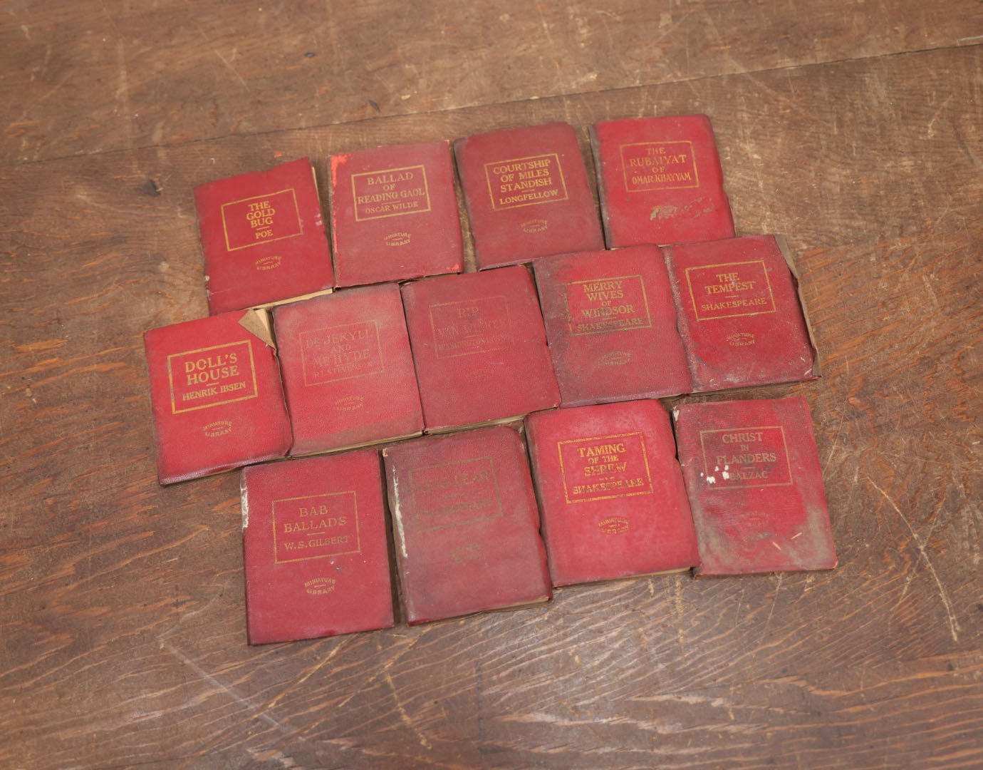 Lot 089 - Grouping Of Thirteen Antique Miniature Library Books, Red Group, Including Edgar Allan Poe's "The Gold Bug,"  R.L. Stevenson's "Dr. Jekyll And Mr. Hyde," Shakespeare And More, Note Wear, Dirty