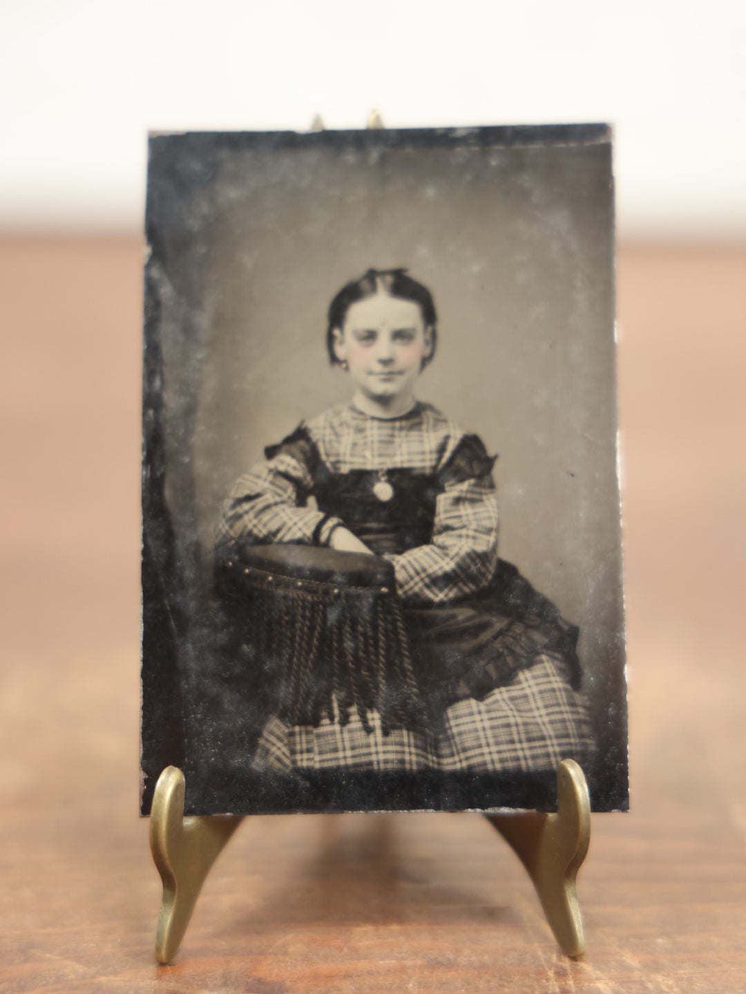 Lot 100 - Antique Tintype Photograph Of Young Girl With Cleft Chin, Slight Smile, Necklace, Sitting In Chair