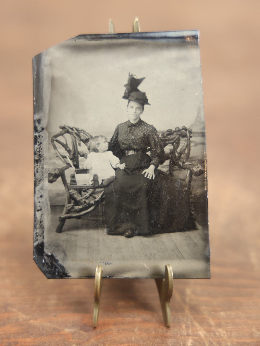 Lot 104 - Antique Tintype Photo Of Mother With Big Hat And Child Sitting On Adirondack Bench With Beach, Boardwalk Backdrop