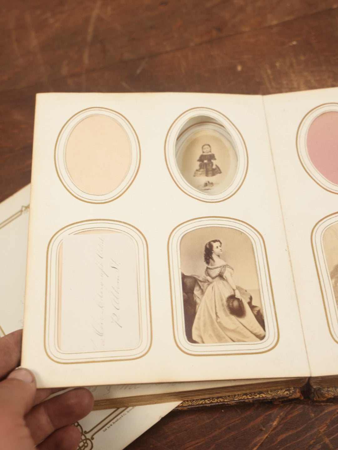 Lot 027 - Antique Family Photograph Album With 36 C.D.V. Photos, 9 Tintypes, And 27 Illustrated Filler Cards Of Various Scenes, Characters, Pretty Women