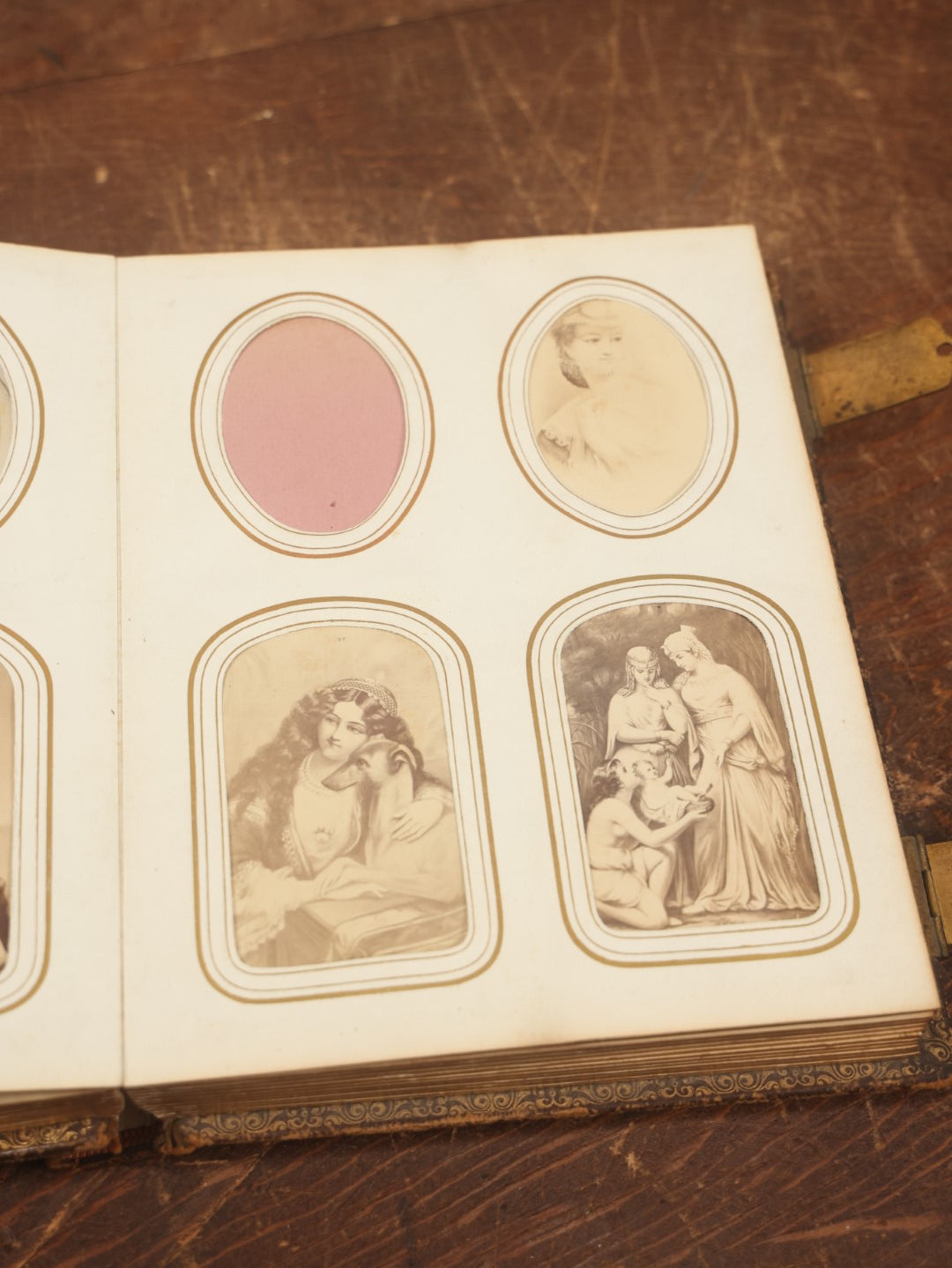 Lot 027 - Antique Family Photograph Album With 36 C.D.V. Photos, 9 Tintypes, And 27 Illustrated Filler Cards Of Various Scenes, Characters, Pretty Women