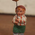 Lot 037 - Rare German Halloween Figurine, Papier Mache Or Bisque, Little Boy Holding Halloween Jack-O-Lantern J.O.L. Pumpkin Balloon