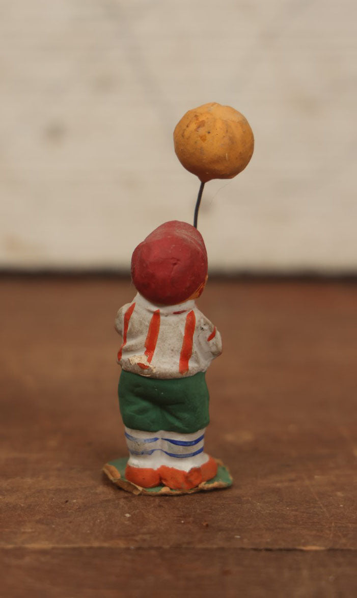 Lot 037 - Rare German Halloween Figurine, Papier Mache Or Bisque, Little Boy Holding Halloween Jack-O-Lantern J.O.L. Pumpkin Balloon