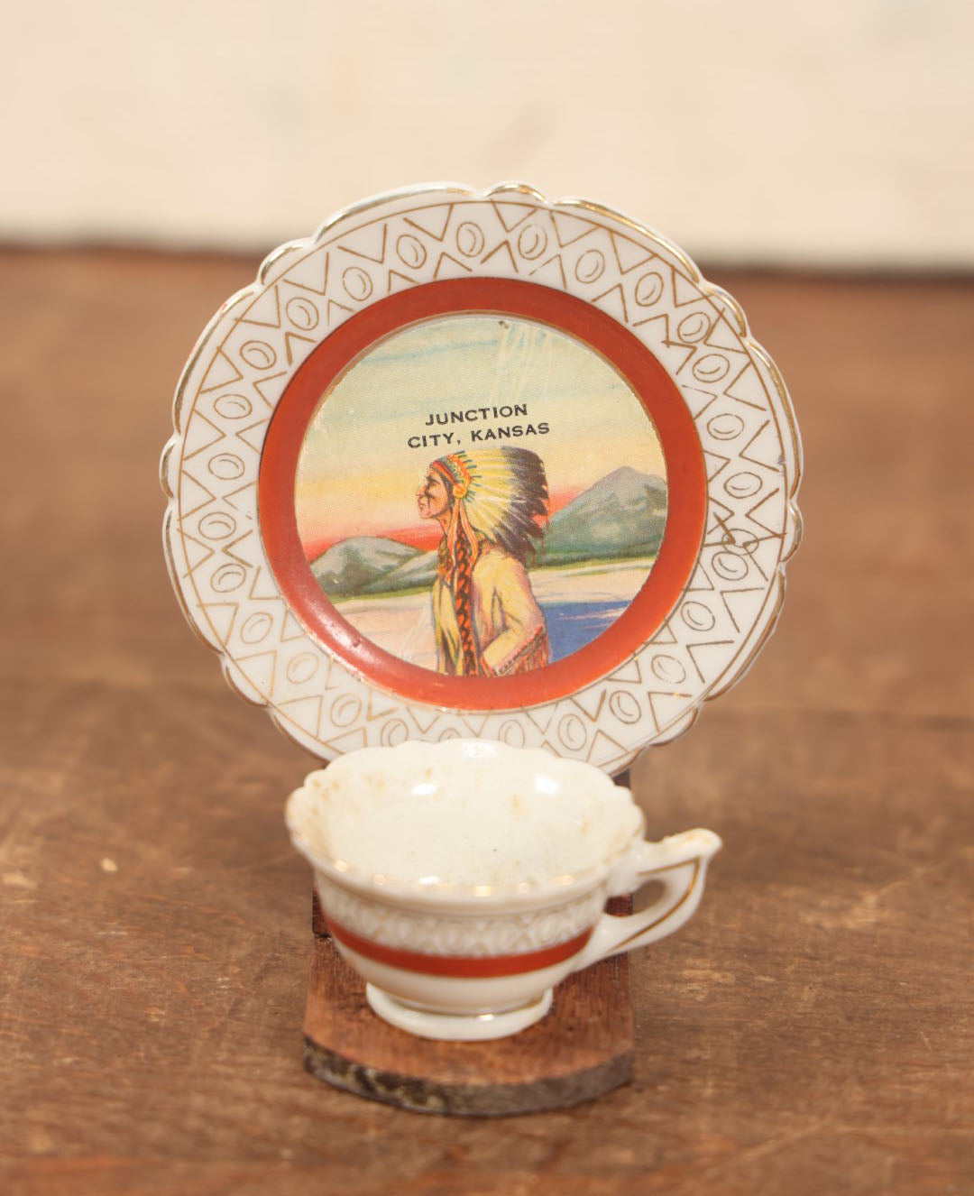 Lot 073 - Vintager Cup And Saucer Glued To Wooden Display, Souvenir Of Junction City, Kansas, Depicting Native American Man