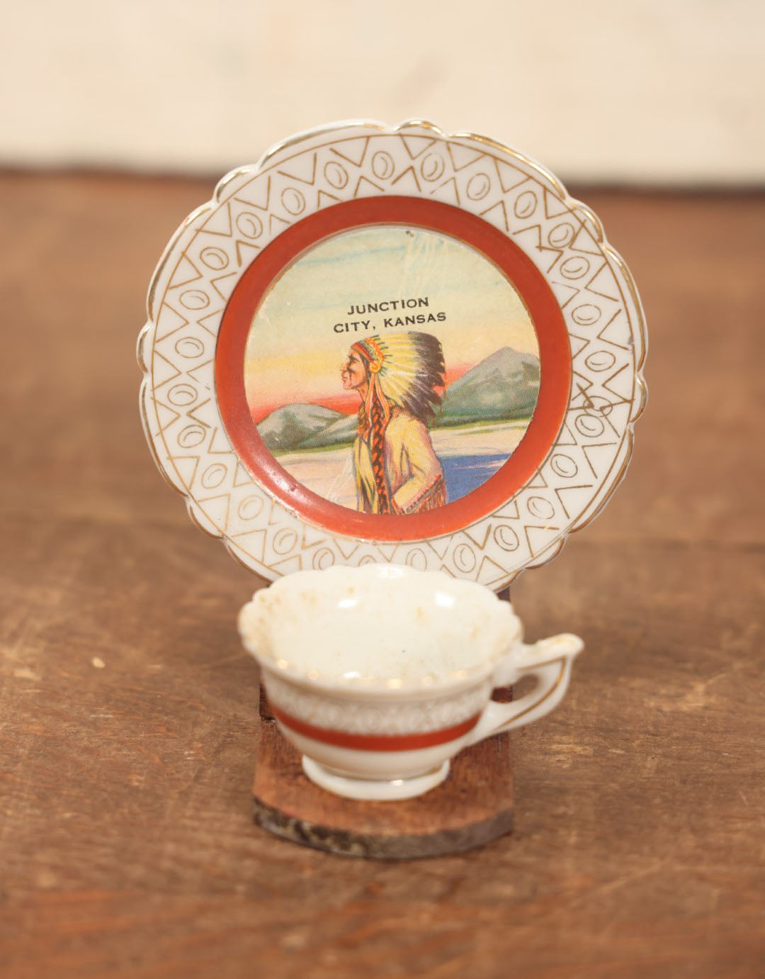 Lot 073 - Vintager Cup And Saucer Glued To Wooden Display, Souvenir Of Junction City, Kansas, Depicting Native American Man