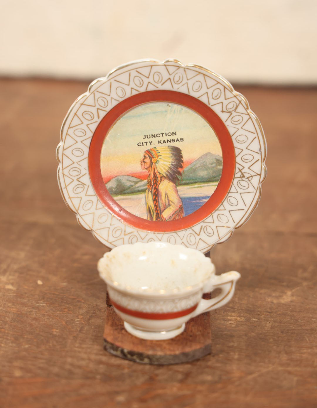 Lot 073 - Vintager Cup And Saucer Glued To Wooden Display, Souvenir Of Junction City, Kansas, Depicting Native American Man