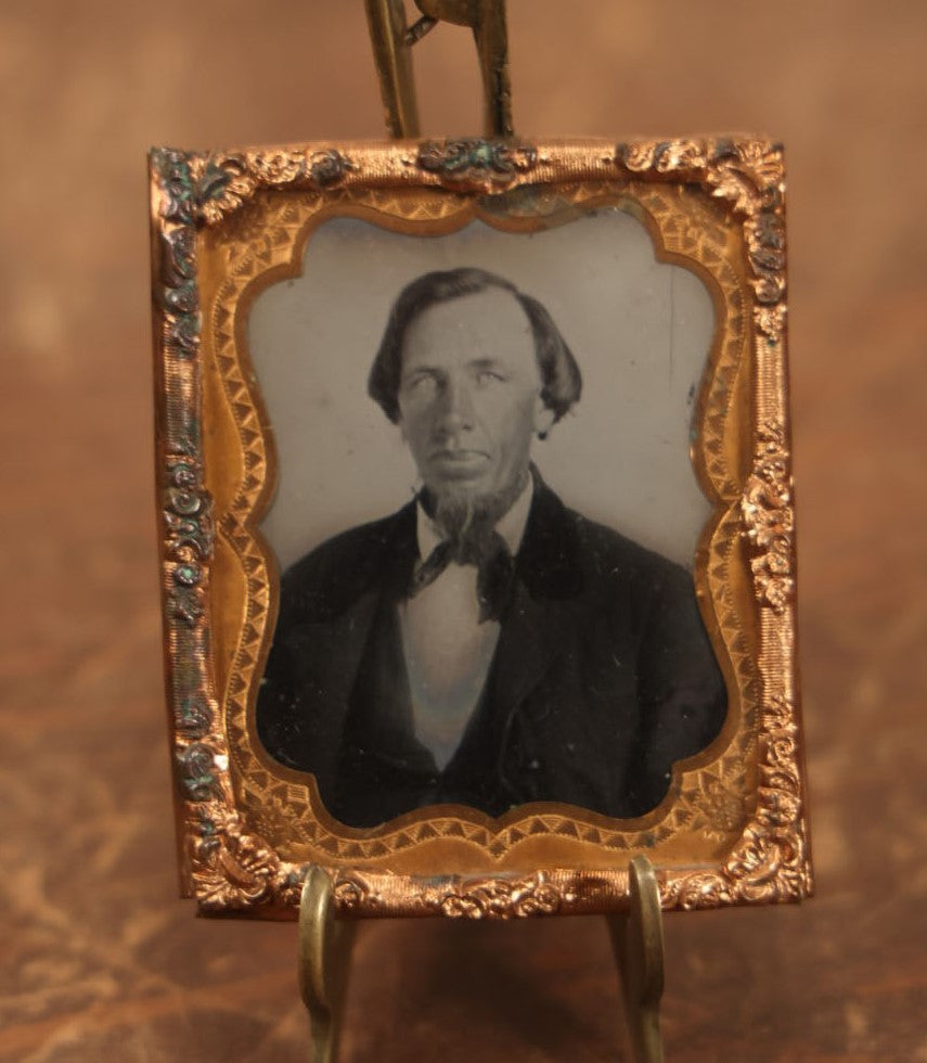 Lot 089 - Tintype Photo Behind Glass With Brass Mat Of Man With Large, Shiny Nose, Big Lips, And Beard