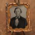 Lot 089 - Tintype Photo Behind Glass With Brass Mat Of Man With Large, Shiny Nose, Big Lips, And Beard